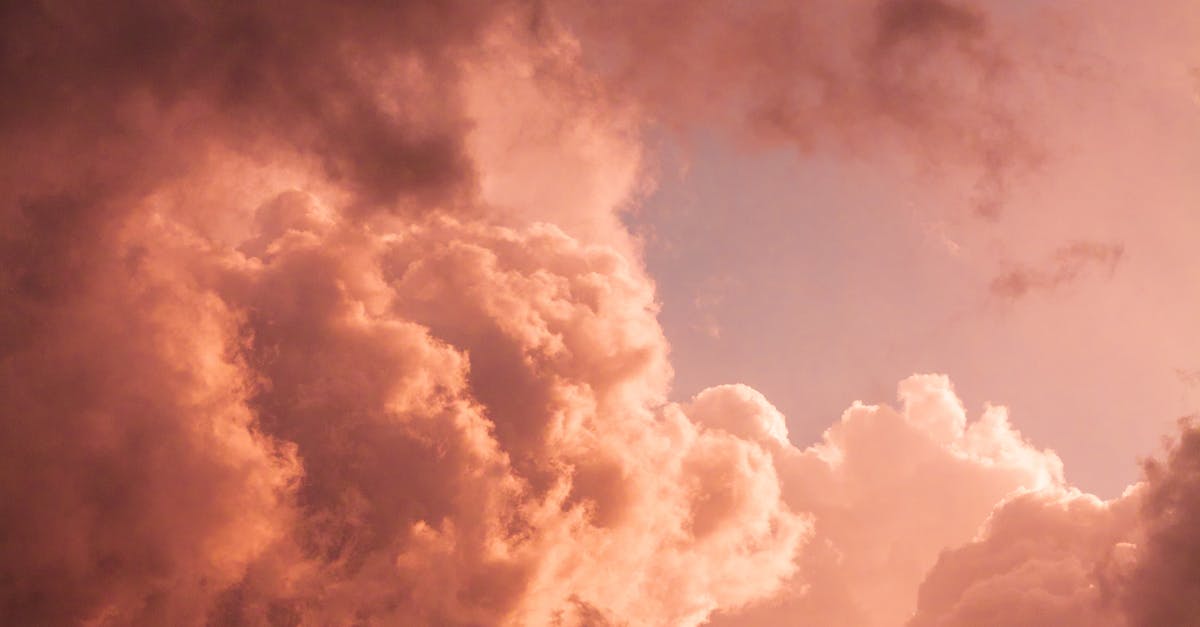 pexels-photo-5677459-5677459 Vibrant pink clouds creating a dramatic scene at twilight, showcasing nature's beauty and majesty.